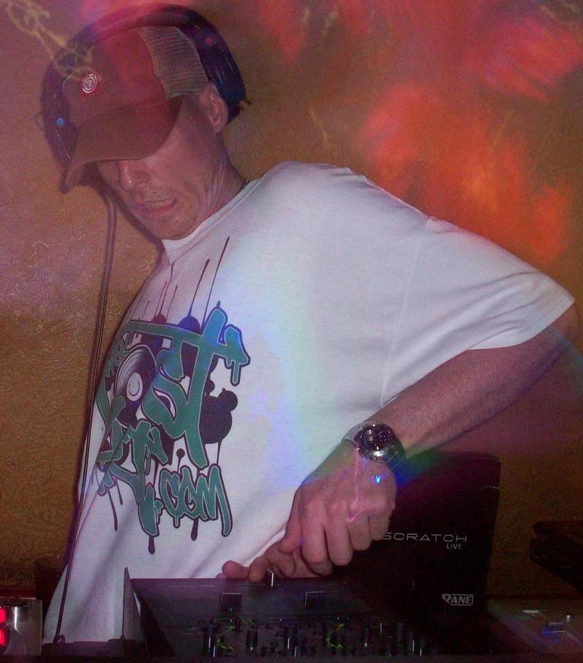 DJ Natural Nate® performing under warm stage lighting with The-Lost-Art™ shirt